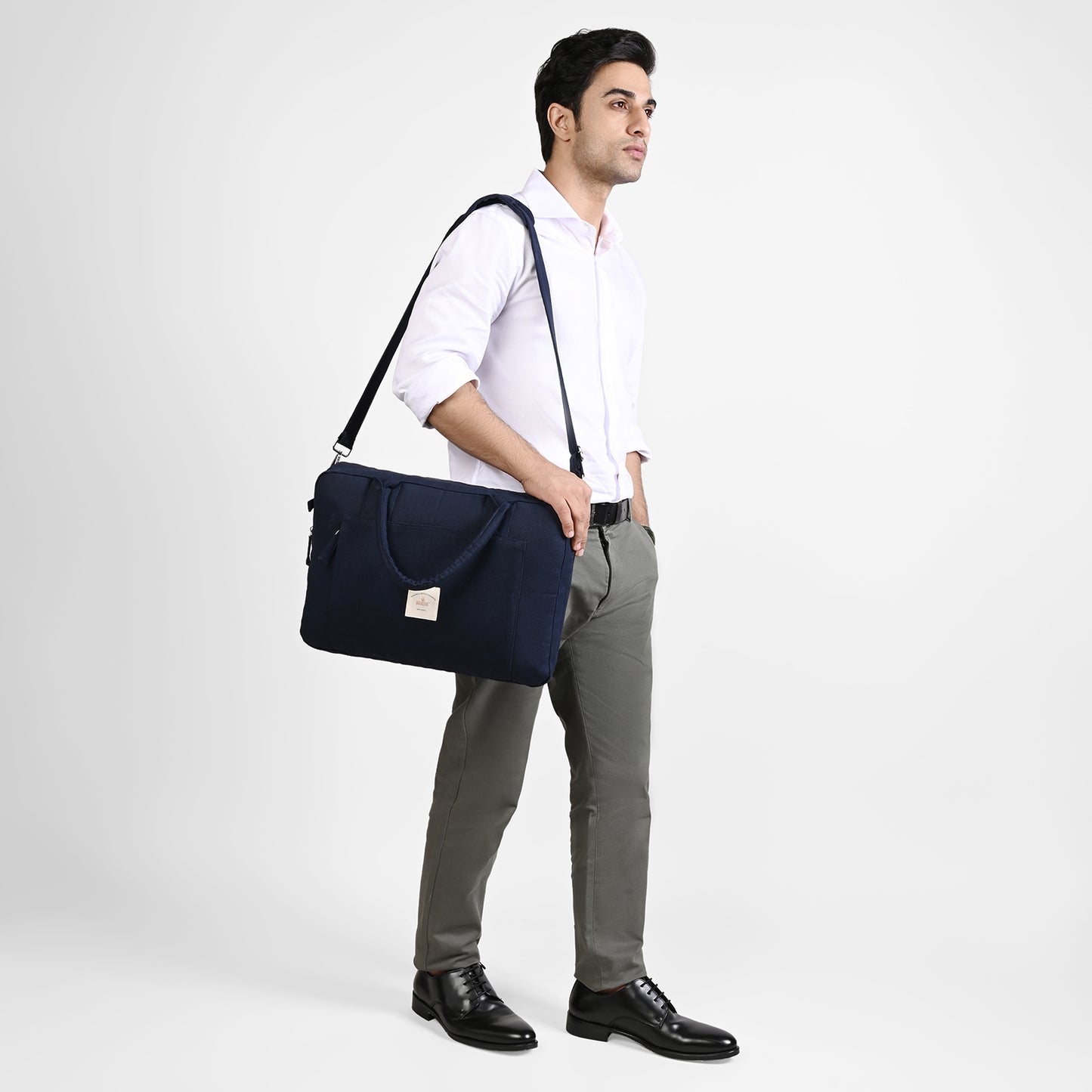 Blue Sustainable Laptop Bag made from Canvas fabric male model image with side handle angel