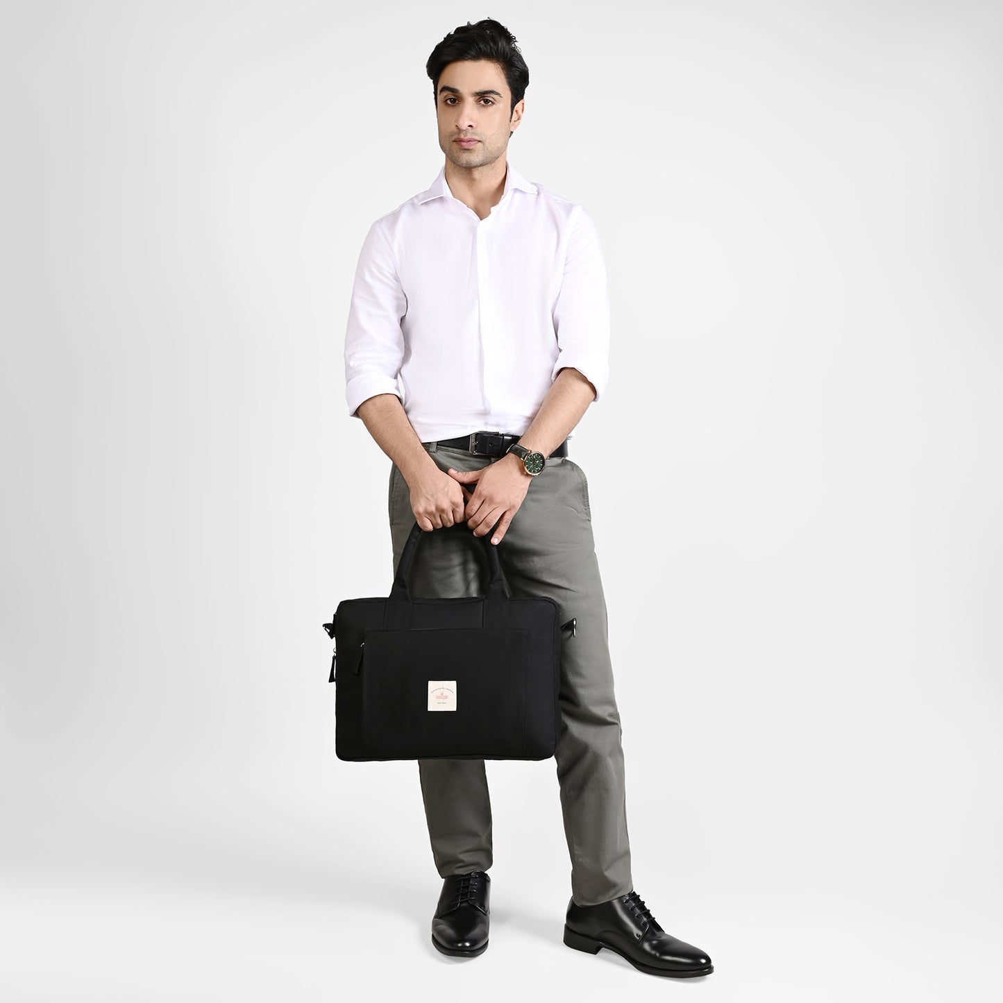 Black Sustainable Laptop Bag made from Canvas fabric male model image with handle angel