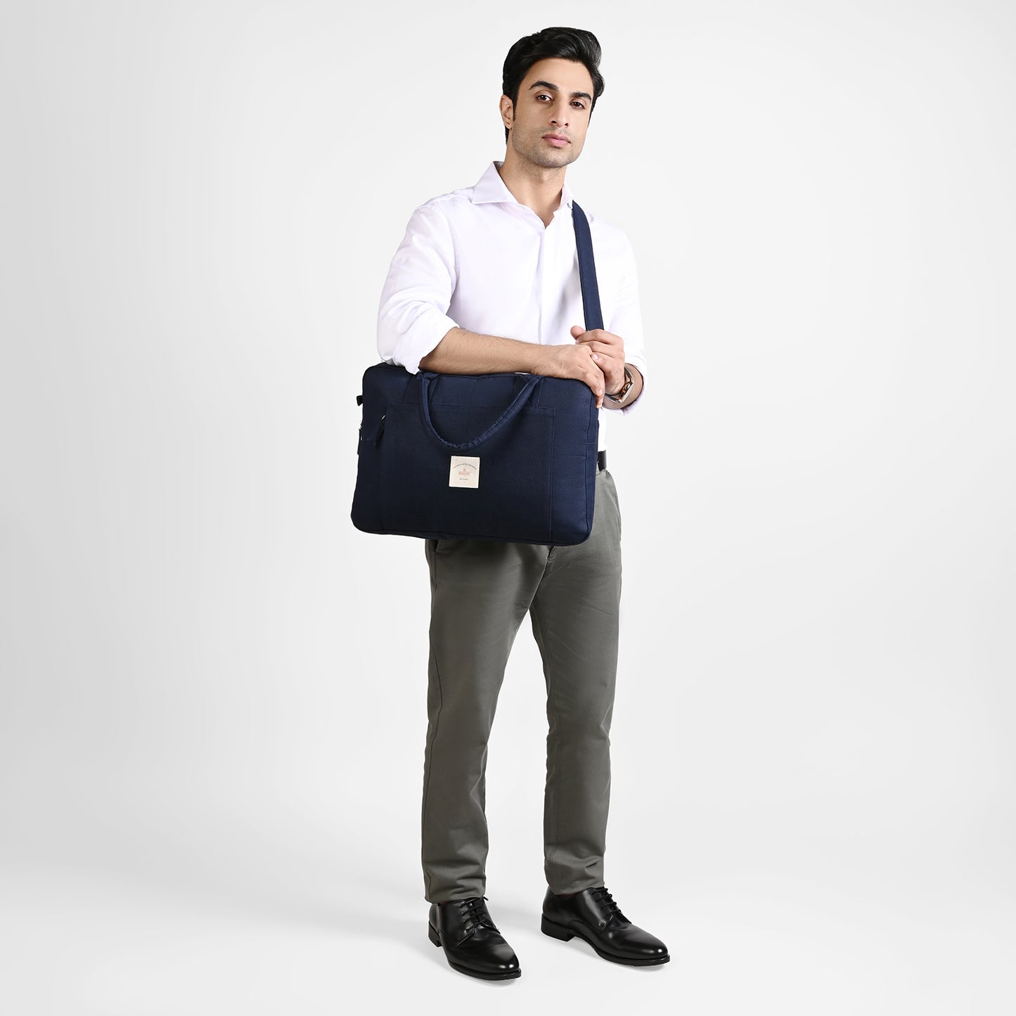Blue Sustainable Laptop Bag made from Canvas fabric model image with crossbody handle angel