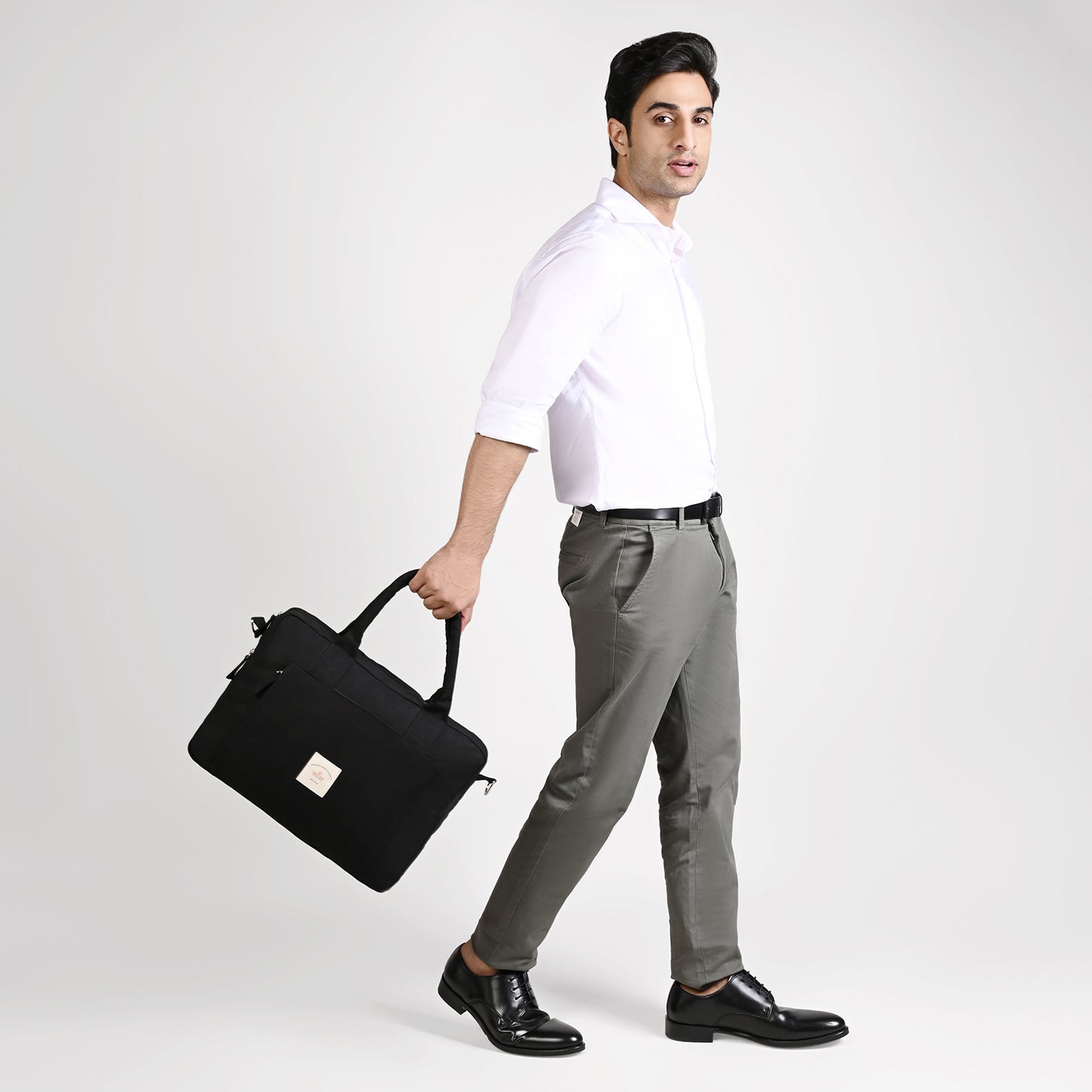 Black Sustainable Laptop Bag made from Canvas fabric male model image with handle angel